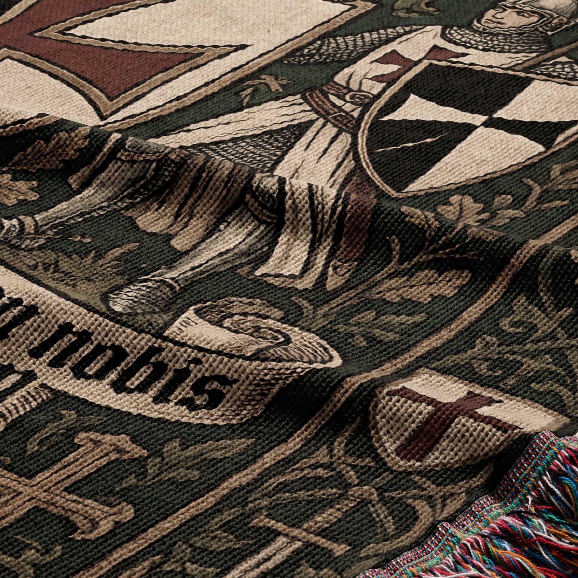 Woven tapestry depicting knights, shields, and text "nobis" with tasseled edges.