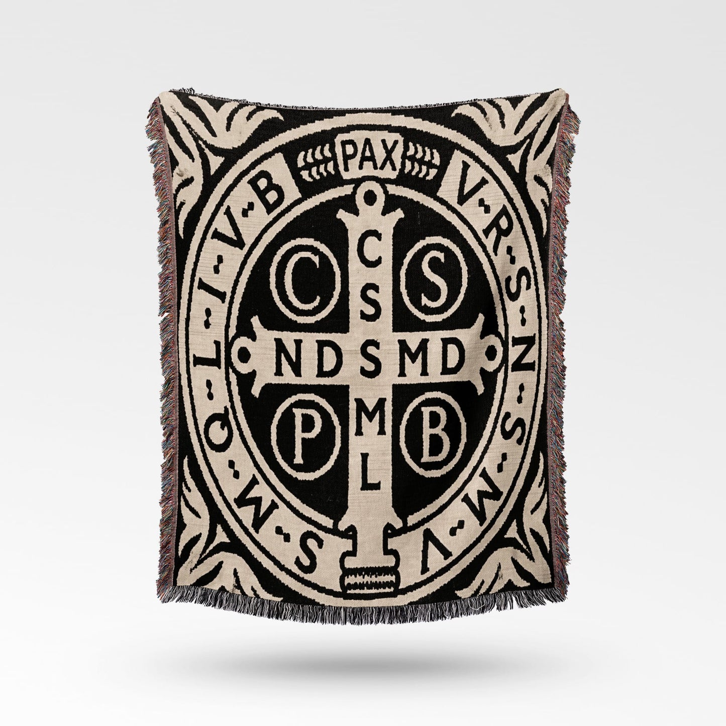 Woven throw with St. Benedict's medal pattern and text.