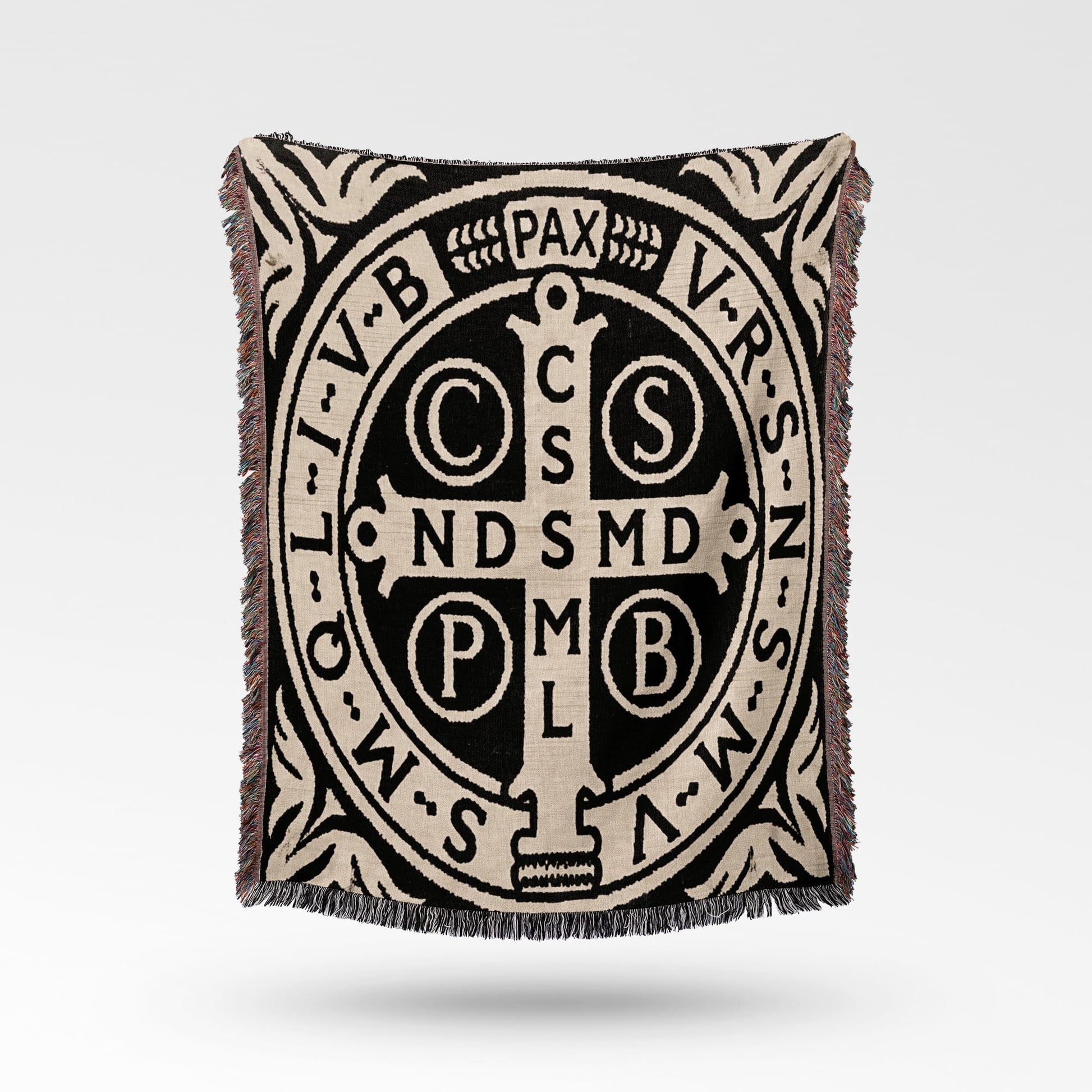 Woven throw with St. Benedict's medal pattern and text.