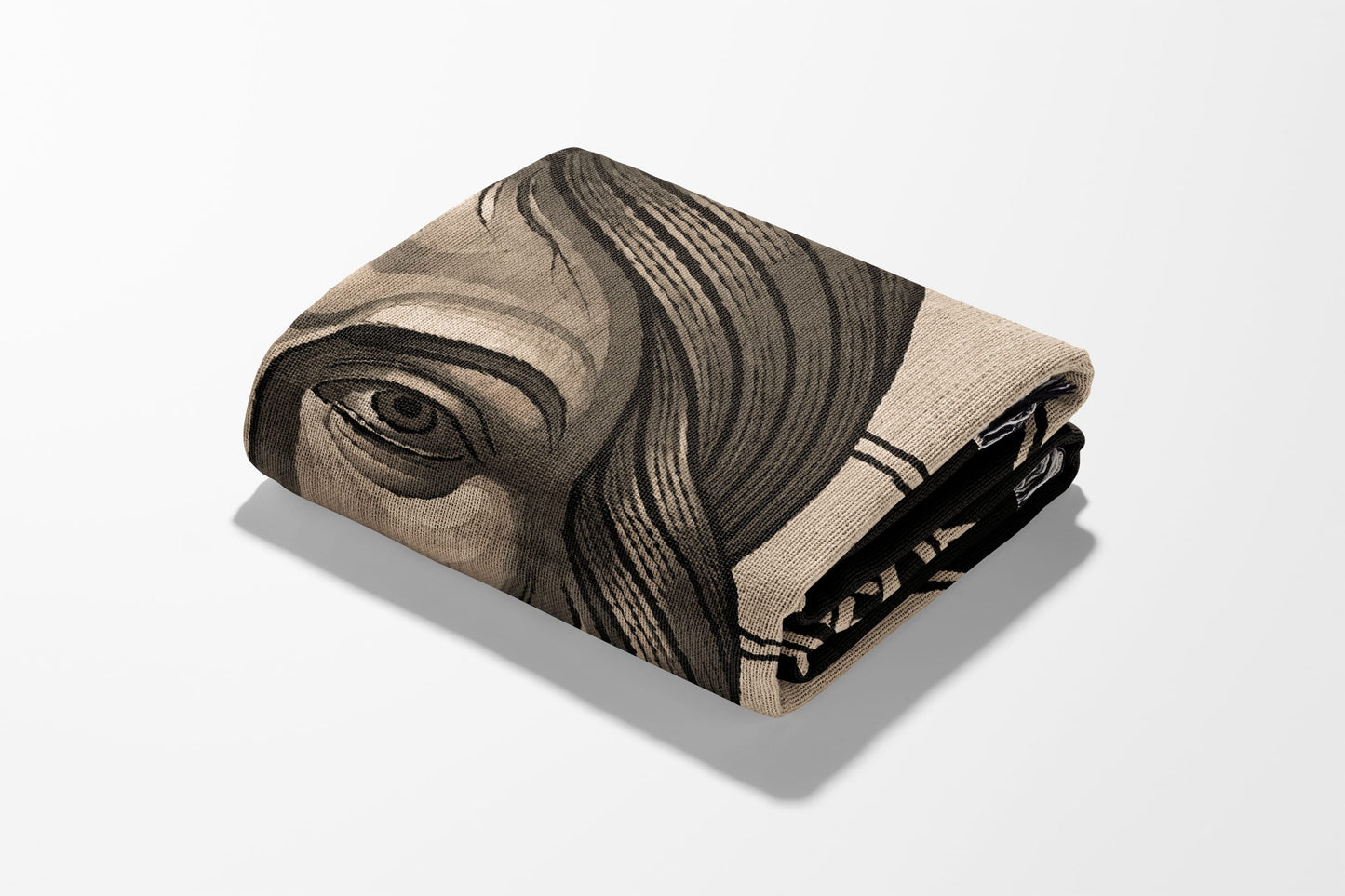 Folded blanket with a close-up illustration of a human eye and hair.