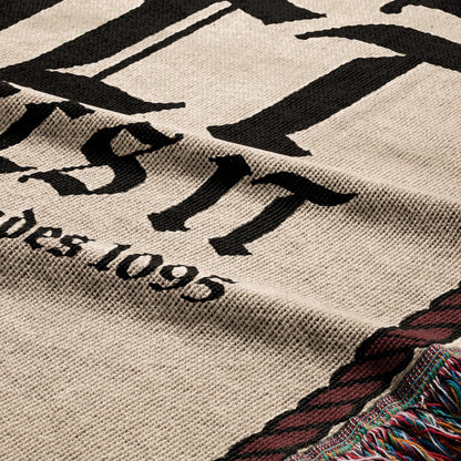 Tapestry with "EST. 1895" text and tasseled edge.