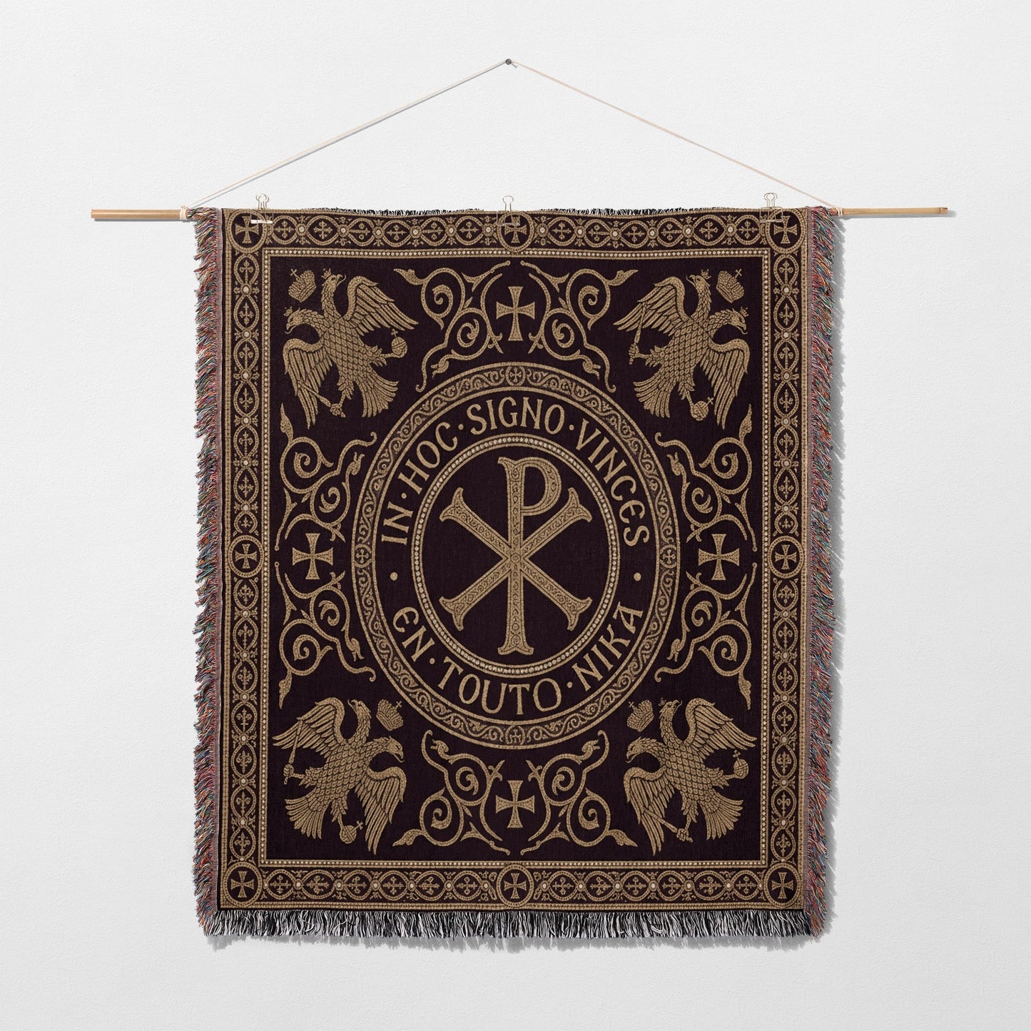 Ornate tapestry with central Chi Rho symbol and eagles, surrounded by Latin text.