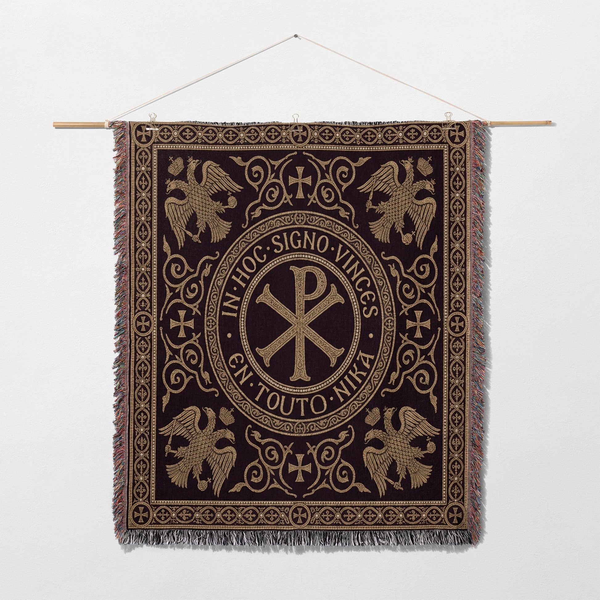 Ornate tapestry with central Chi Rho symbol and eagles, surrounded by Latin text.