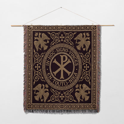 Ornate tapestry with central Chi Rho symbol and eagles, surrounded by Latin text.