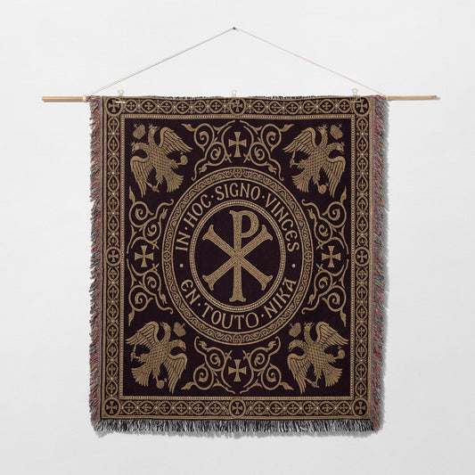 Ornate tapestry with central Chi Rho symbol and eagles, surrounded by Latin text.