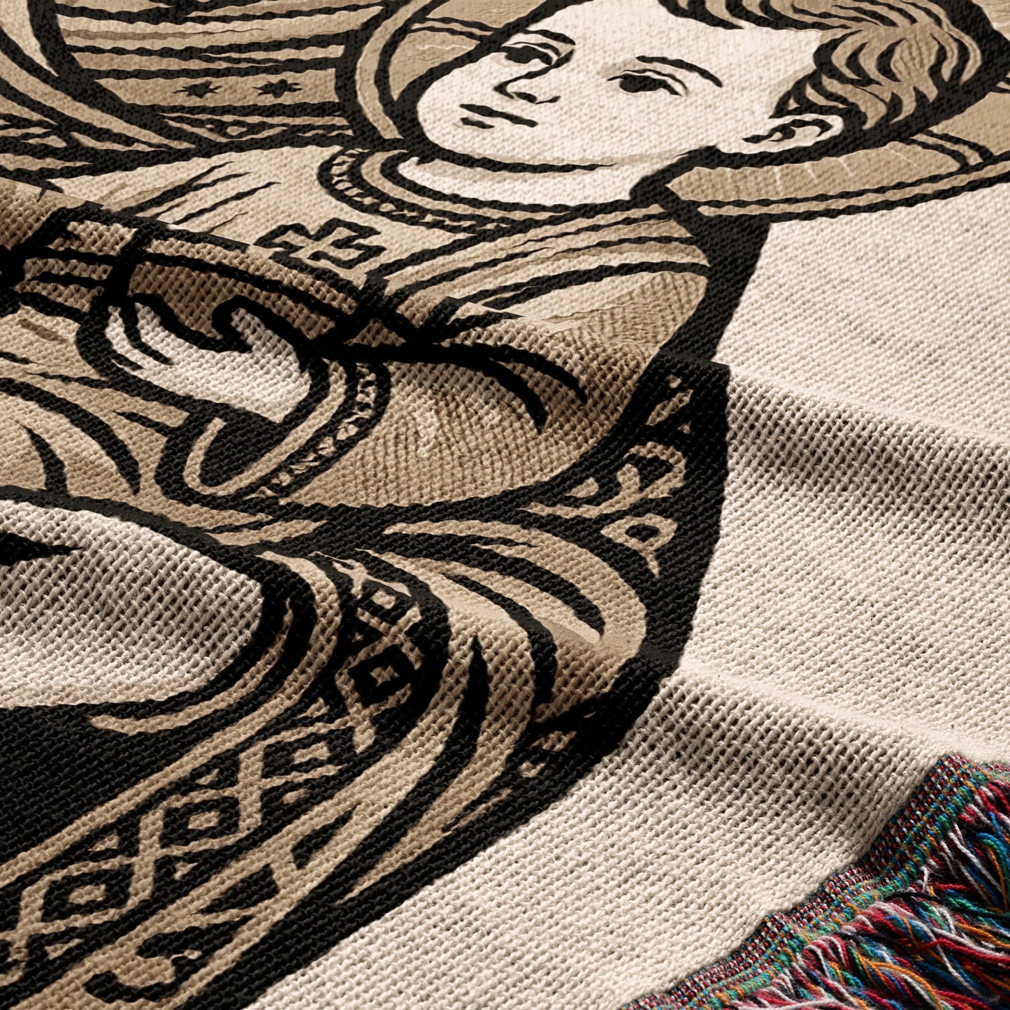 Tapestry blanket featuring an angelic child in a decorative border with fringed edge.
