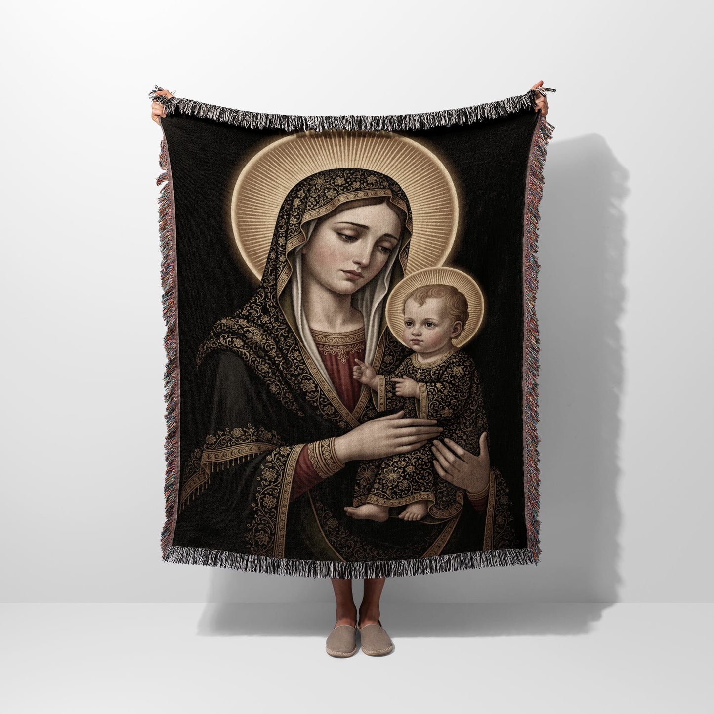 Madonna and Child depicted on a woven tapestry blanket with halo.