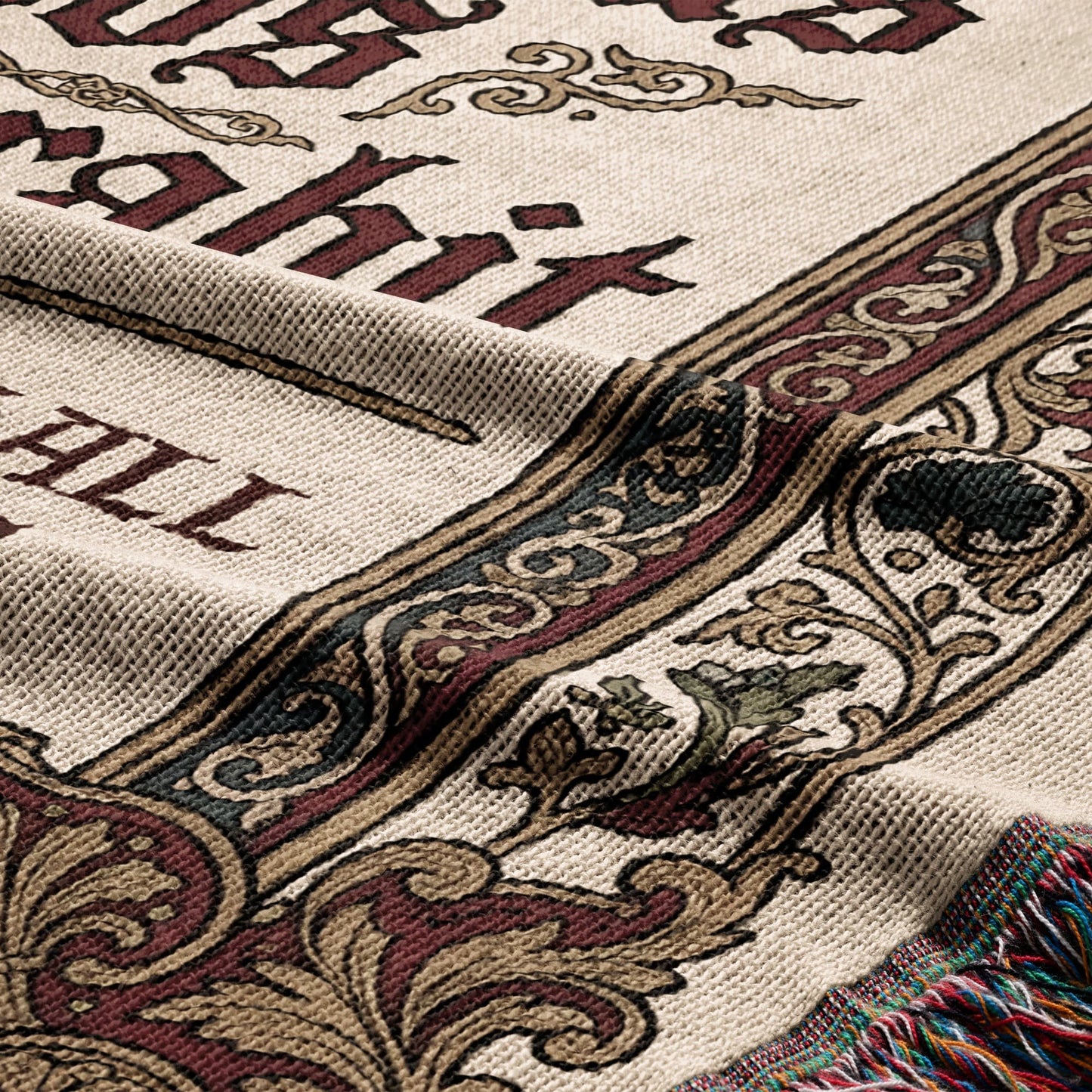 Woven blanket with ornate border, featuring "The Hobbit" in decorative text.