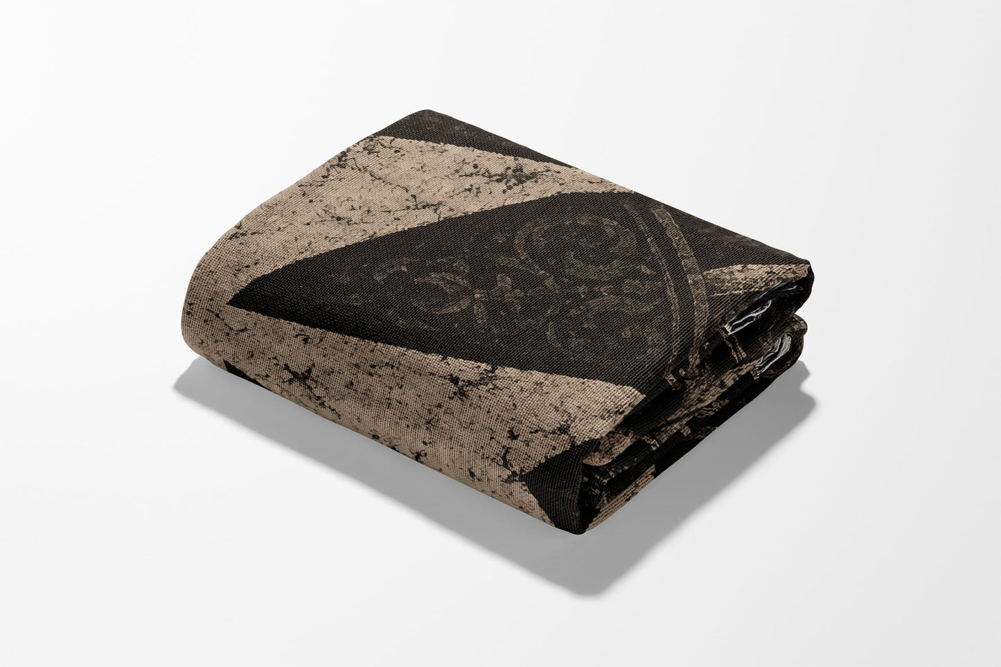 Folded blanket with dark brown damask pattern on tan background.