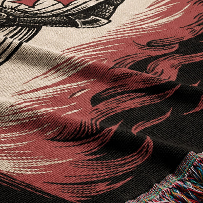 Woven blanket with tribal fire pattern and fringed edge.