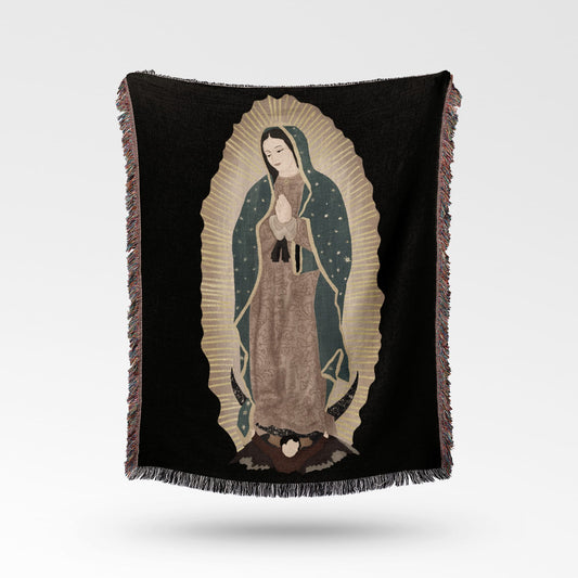 Black throw blanket with an embroidered image of the Virgin of Guadalupe.