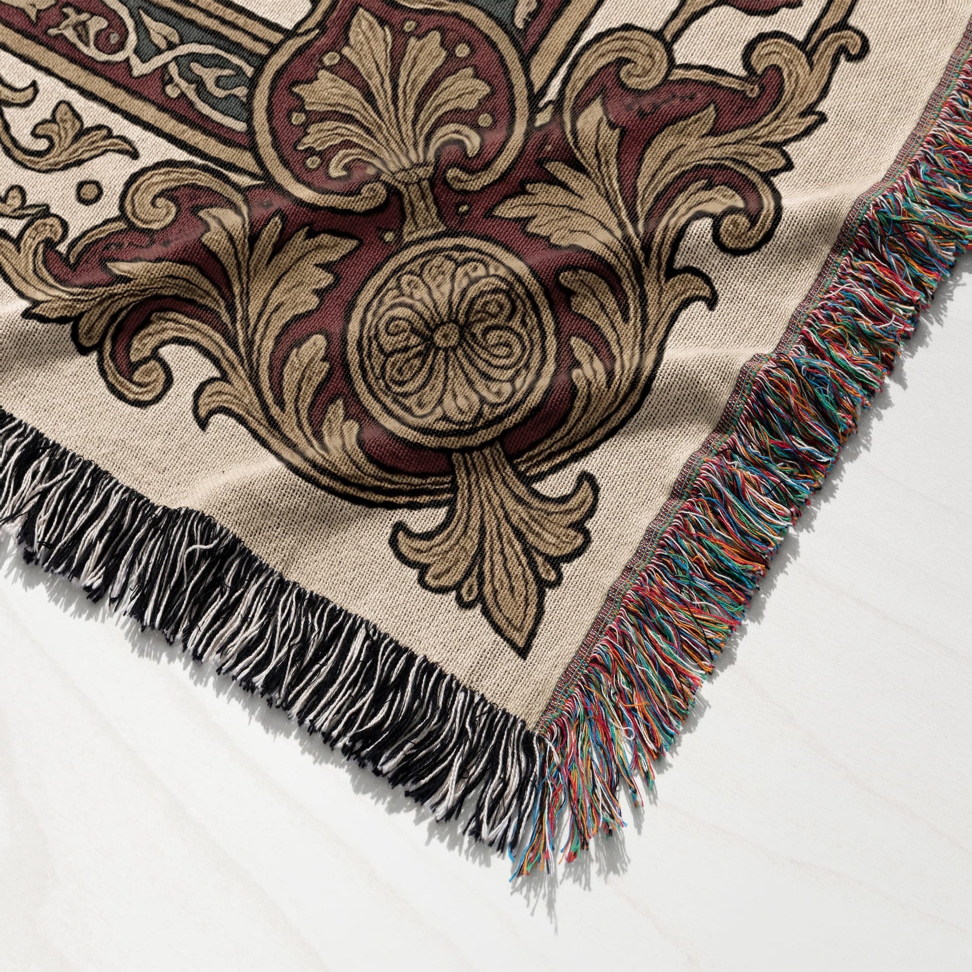 Tapestry throw blanket with ornate medieval pattern and colorful fringed edges.