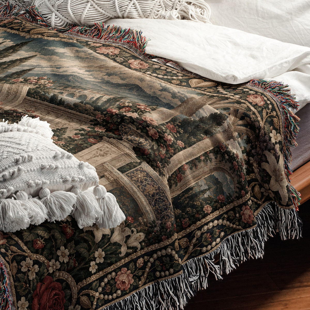 A woven tapestry throw blanket featuring a classic landscape scene draped over a bed.
