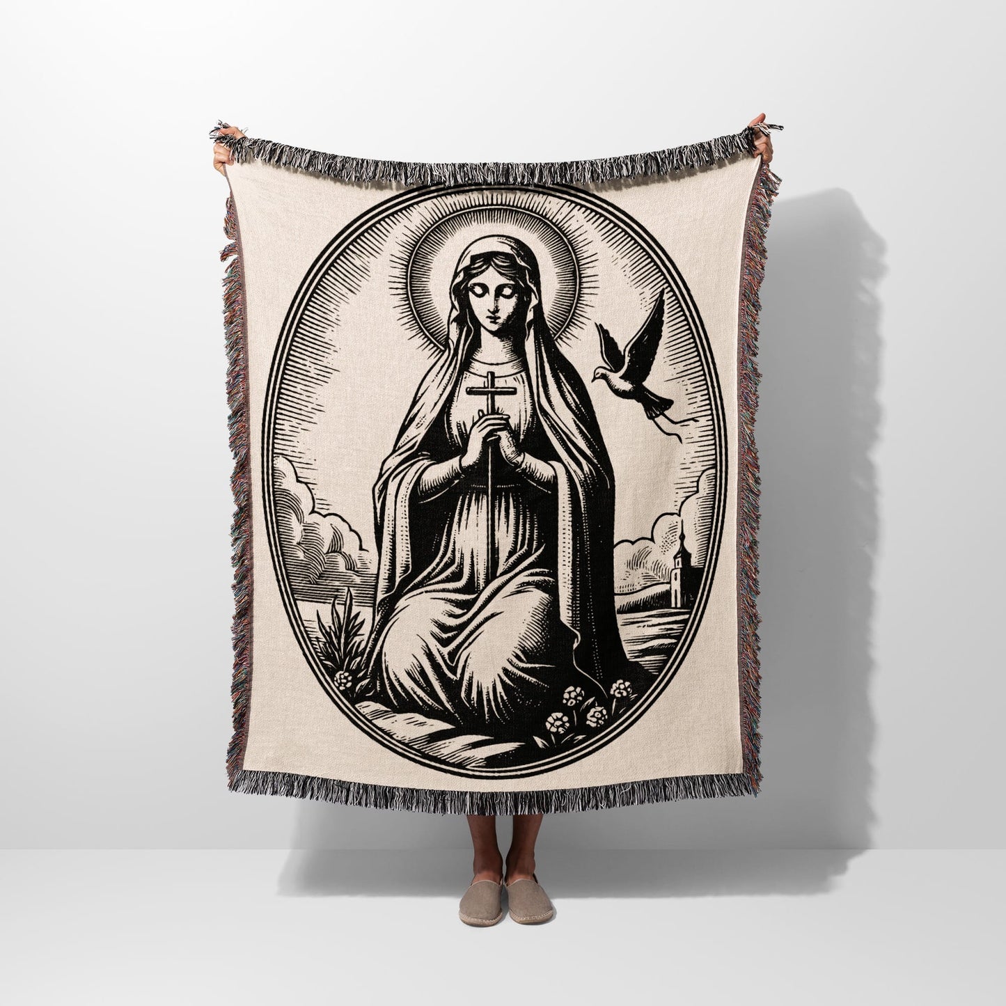 Oval tapestry with religious imagery of Mary holding a cross, a dove, and surrounding clouds.