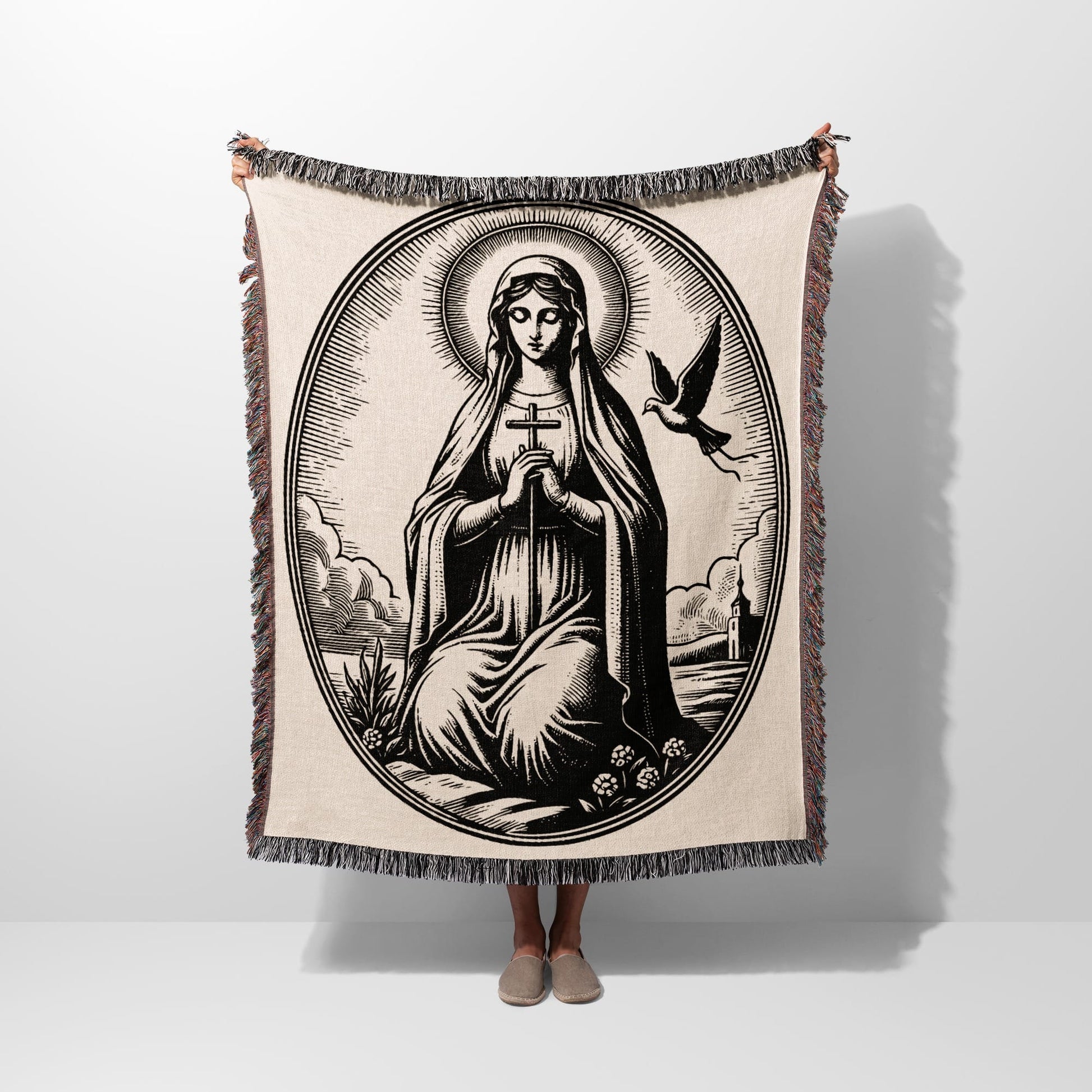 Oval tapestry with religious imagery of Mary holding a cross, a dove, and surrounding clouds.