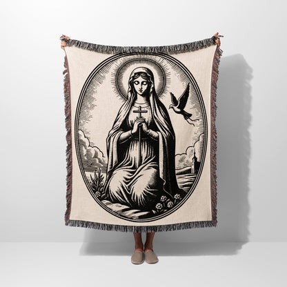 Oval tapestry with religious imagery of Mary holding a cross, a dove, and surrounding clouds.