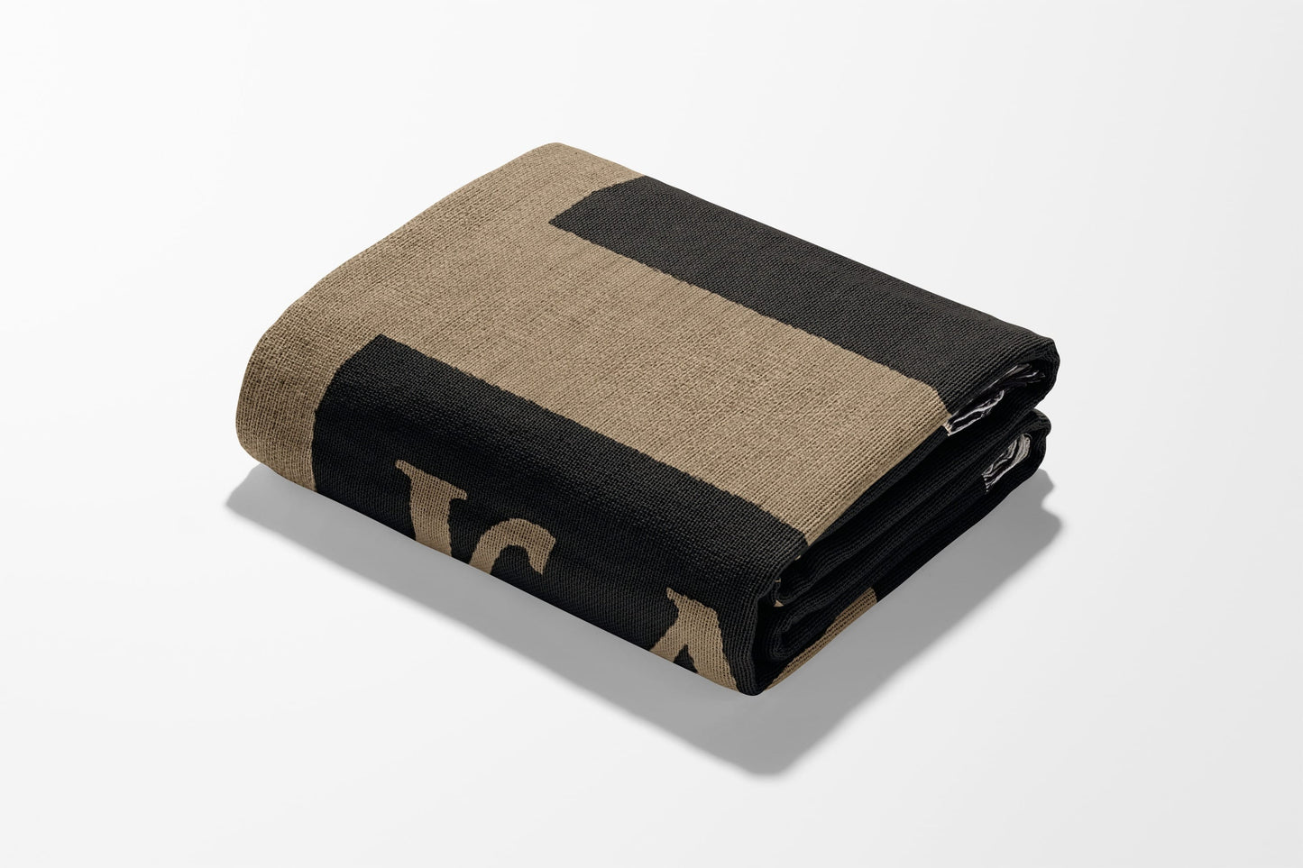Folded blanket with "L" and "A" design in black and tan.