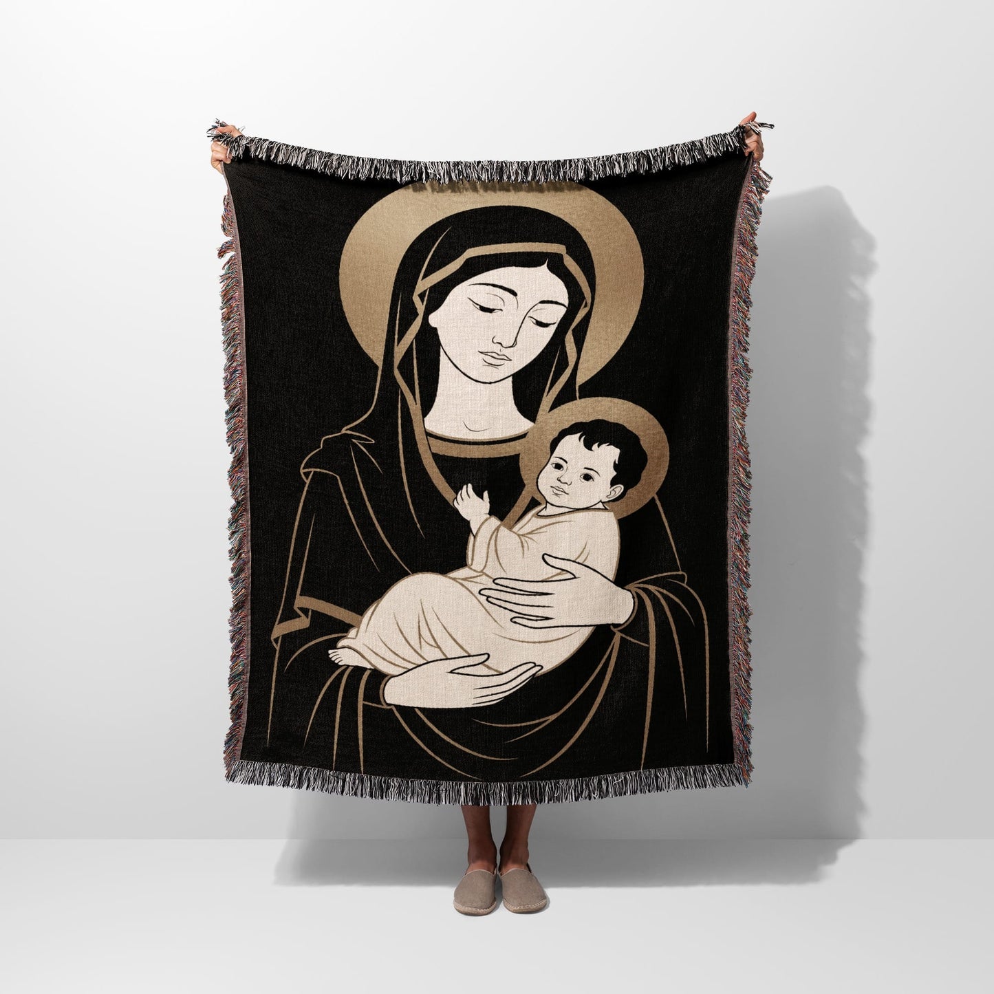 Black tapestry featuring Virgin Mary holding baby Jesus with halos.