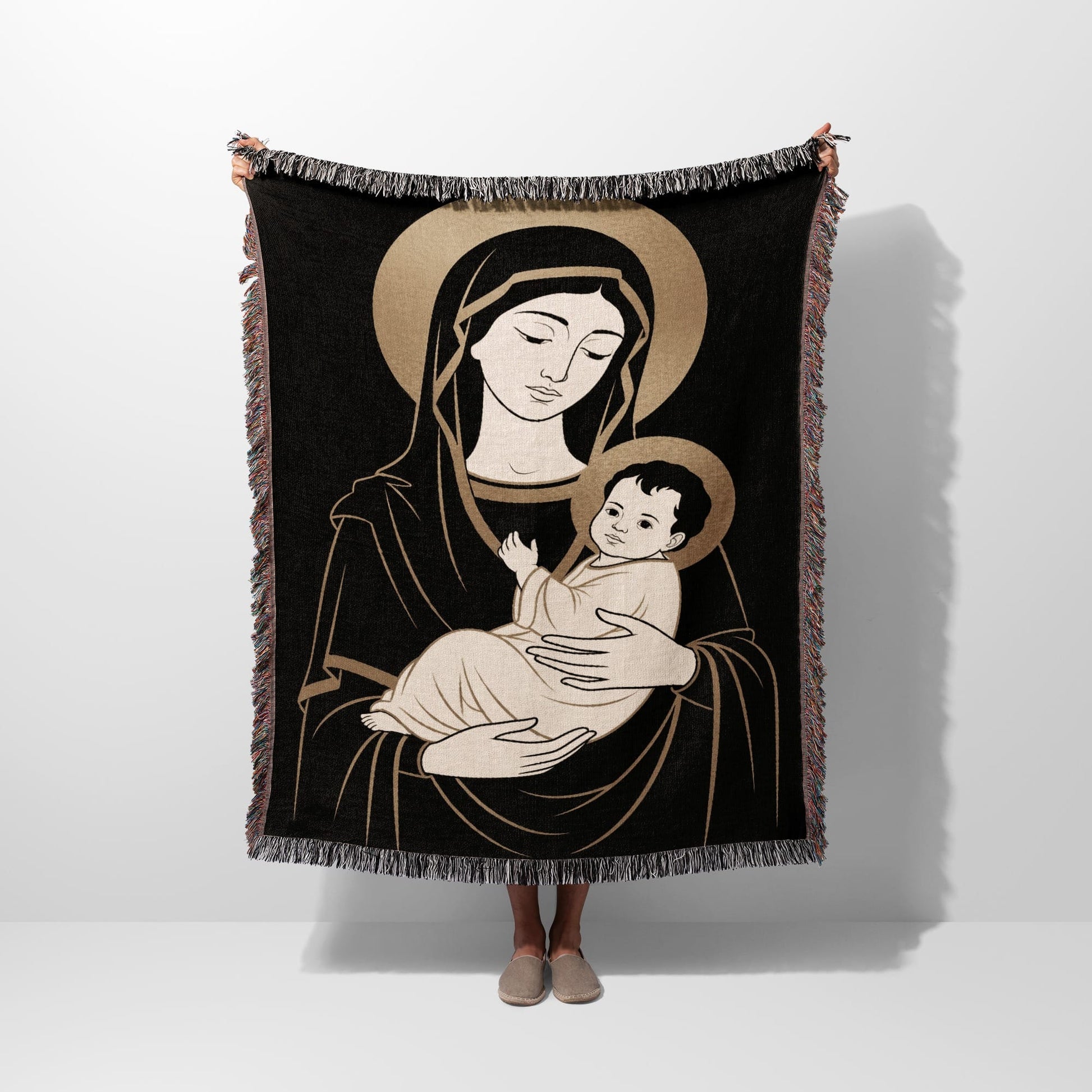 Black tapestry featuring Virgin Mary holding baby Jesus with halos.