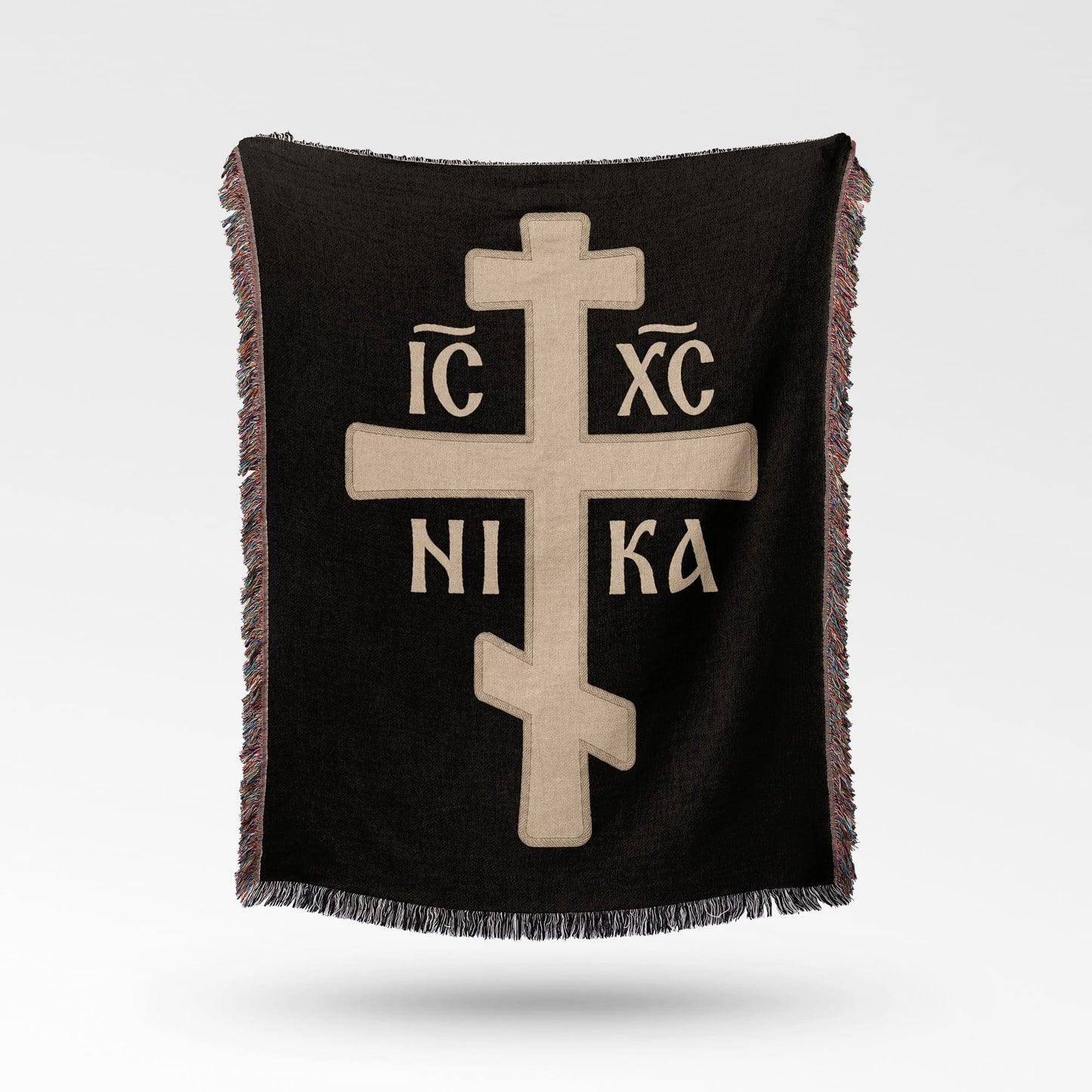 Black throw blanket with a large, light brown Orthodox cross and Greek text.