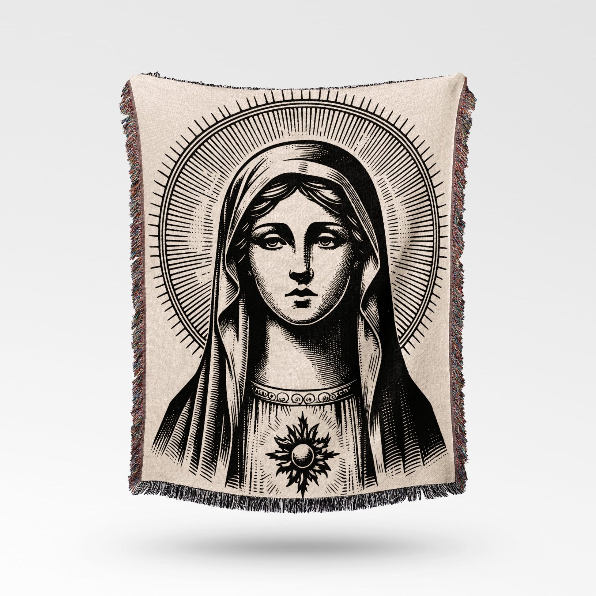 Black and white tapestry depicting the Virgin Mary with a halo and radiant sun emblem.