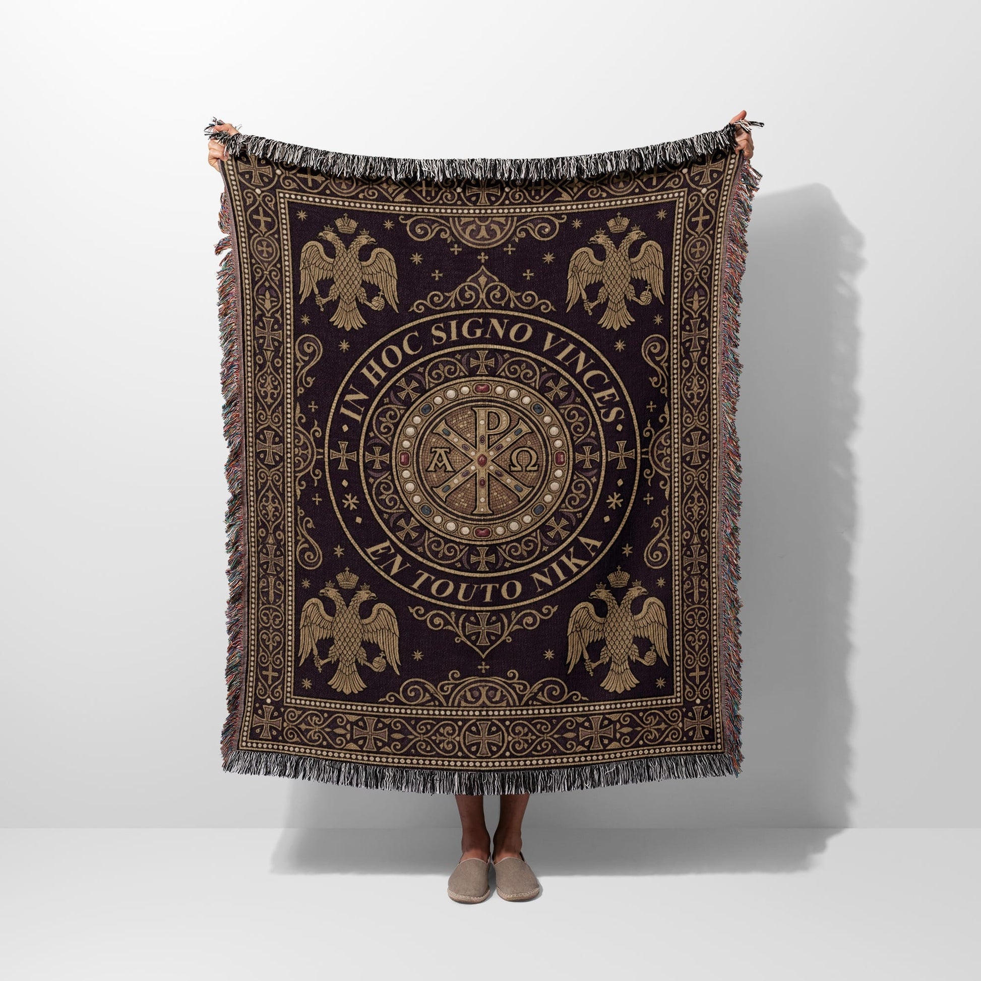 Dark woven blanket with central medallion, eagles, and Greek text "IN HOC SIGNO VINCES EN TOUTO NIKA".