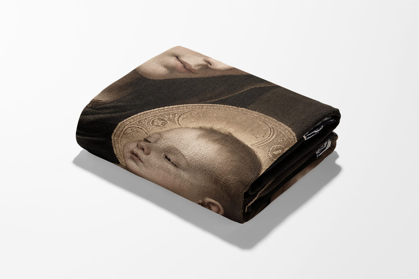 Folded tapestry featuring a Renaissance-style depiction of a baby's face with a halo.