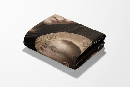Folded tapestry featuring a Renaissance-style depiction of a baby's face with a halo.