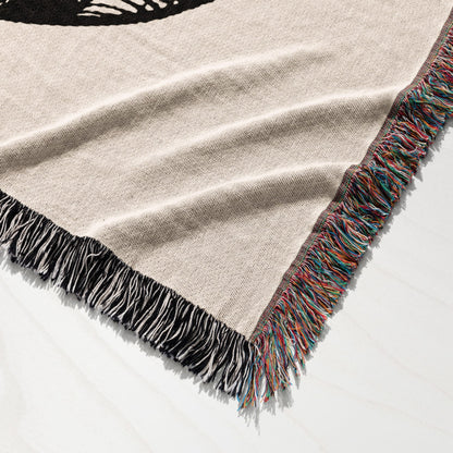 Woven tapestry throw blanket with a cream background and a black graphic.