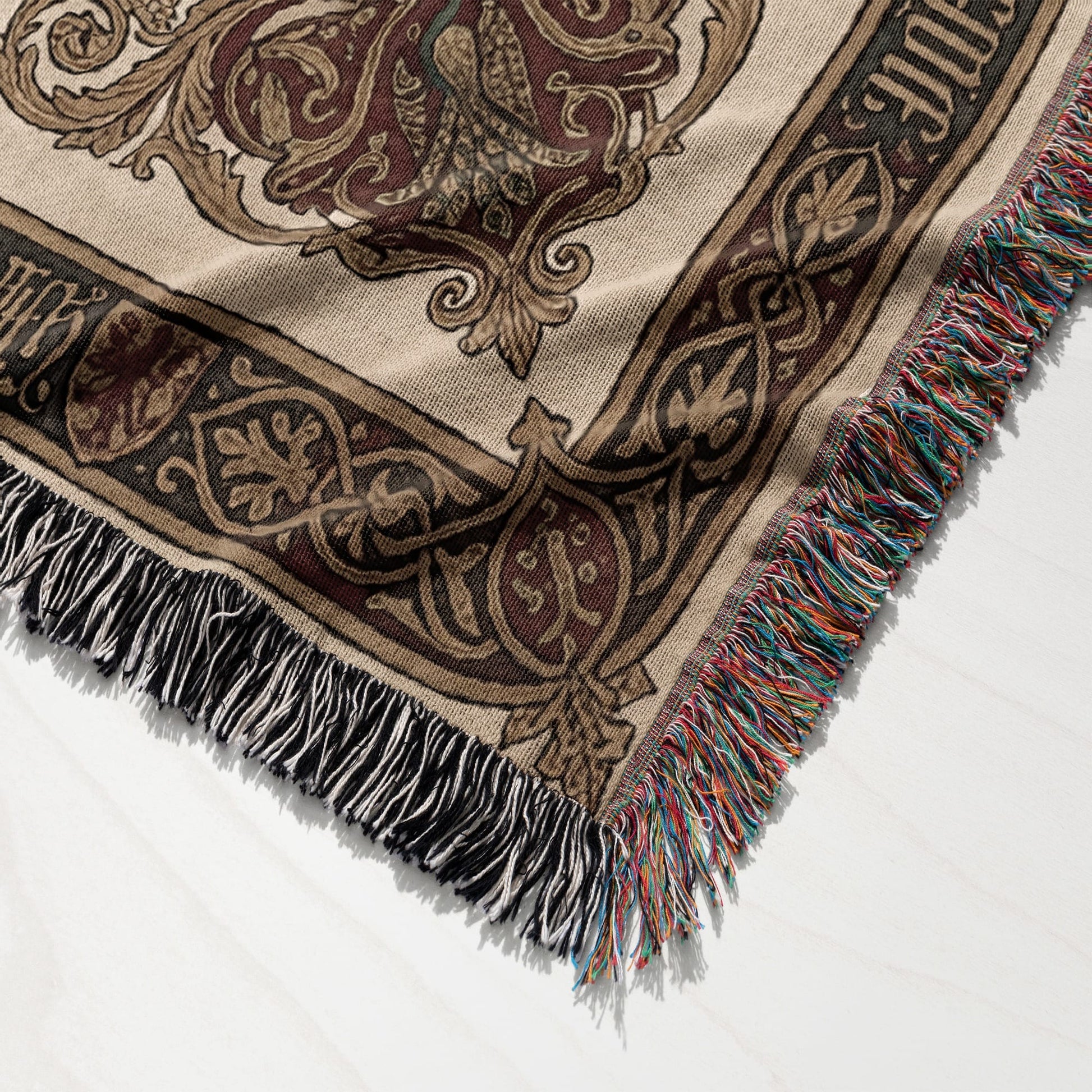 Tapestry throw blanket with ornate medieval pattern and fringed edges.