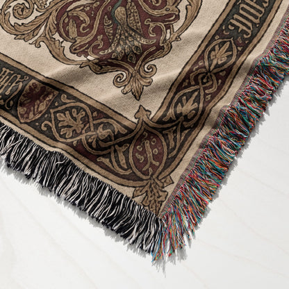 Tapestry throw blanket with ornate medieval pattern and fringed edges.