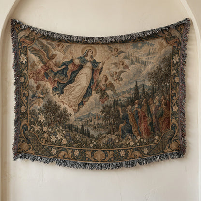 Woven tapestry hanging on a neutral wall, depicting the Assumption of Mary surrounded by angels and onlookers.
