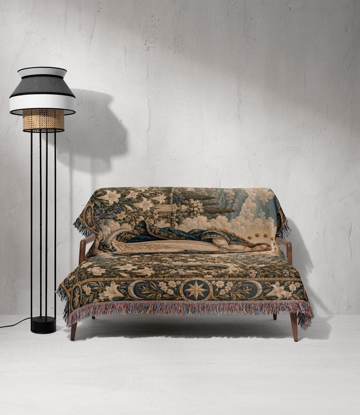 A wooden sofa draped in a detailed, medieval-style tapestry featuring floral patterns and a reclining figure.