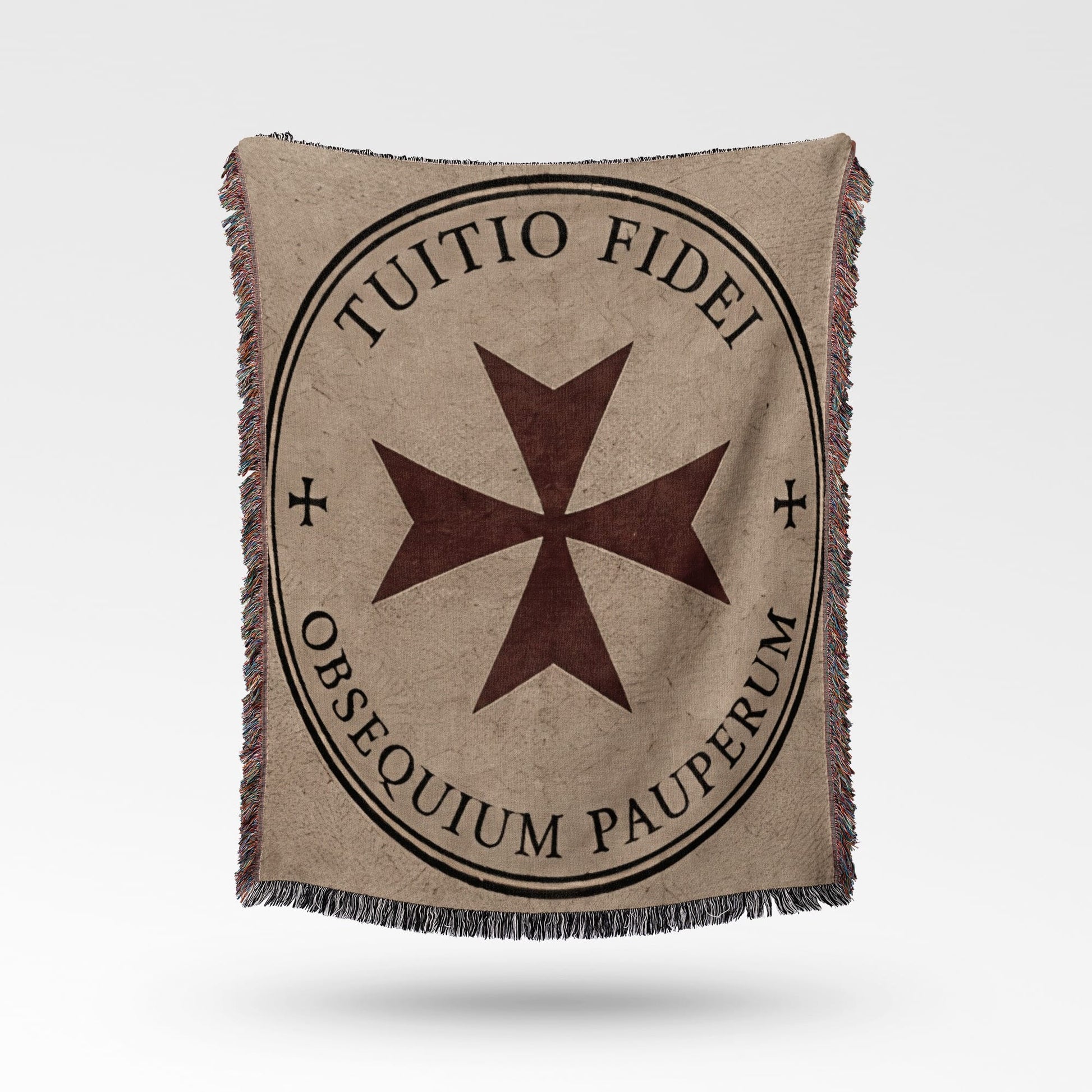 Tapestry blanket with a Maltese cross and Latin text "TUITIO FIDEI OBSEQUIUM PAUPERUM."