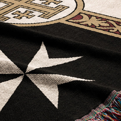 Black throw with white Maltese cross design and ornate border, multi-colored fringe.