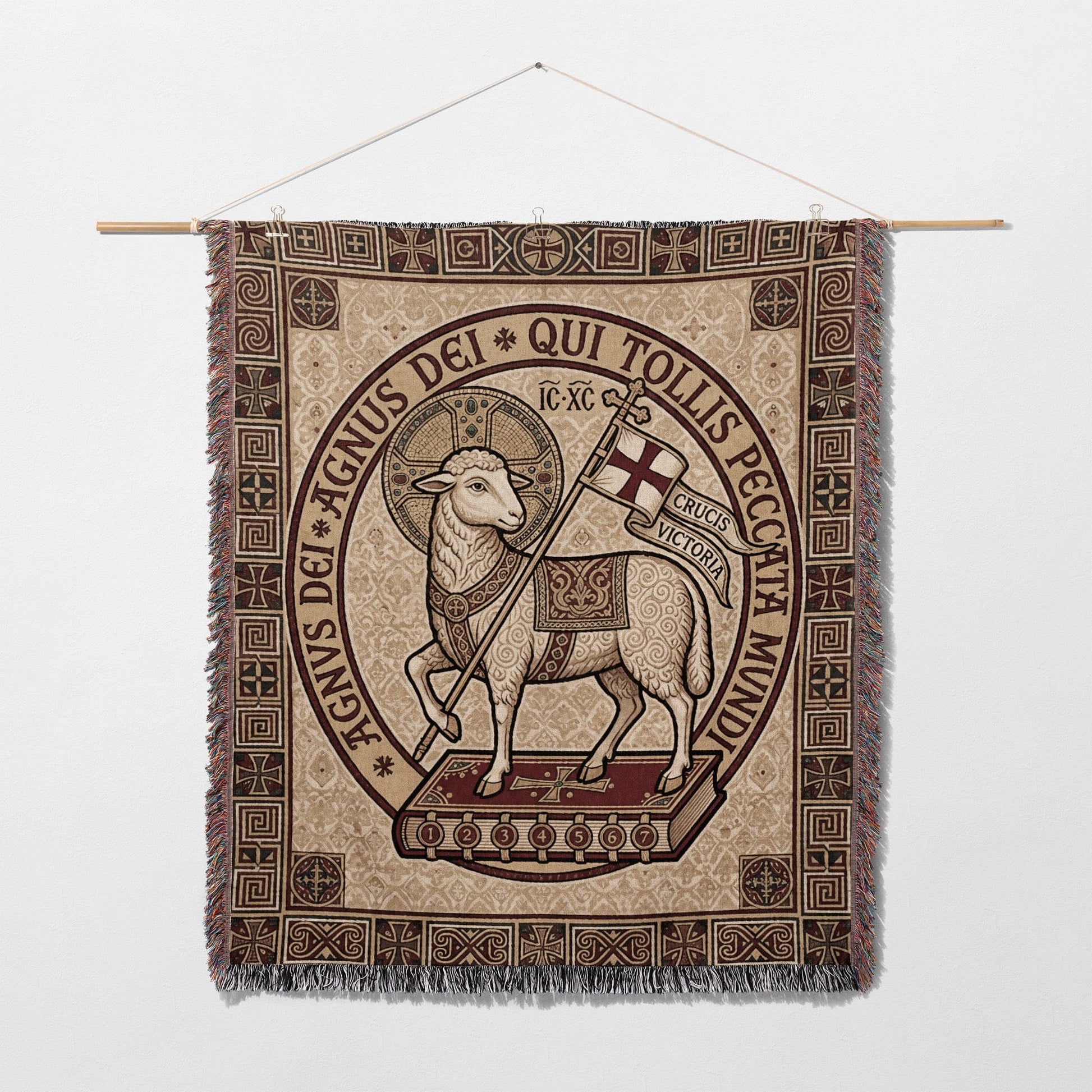 Tapestry of the Agnus Dei with Latin text and decorative border.