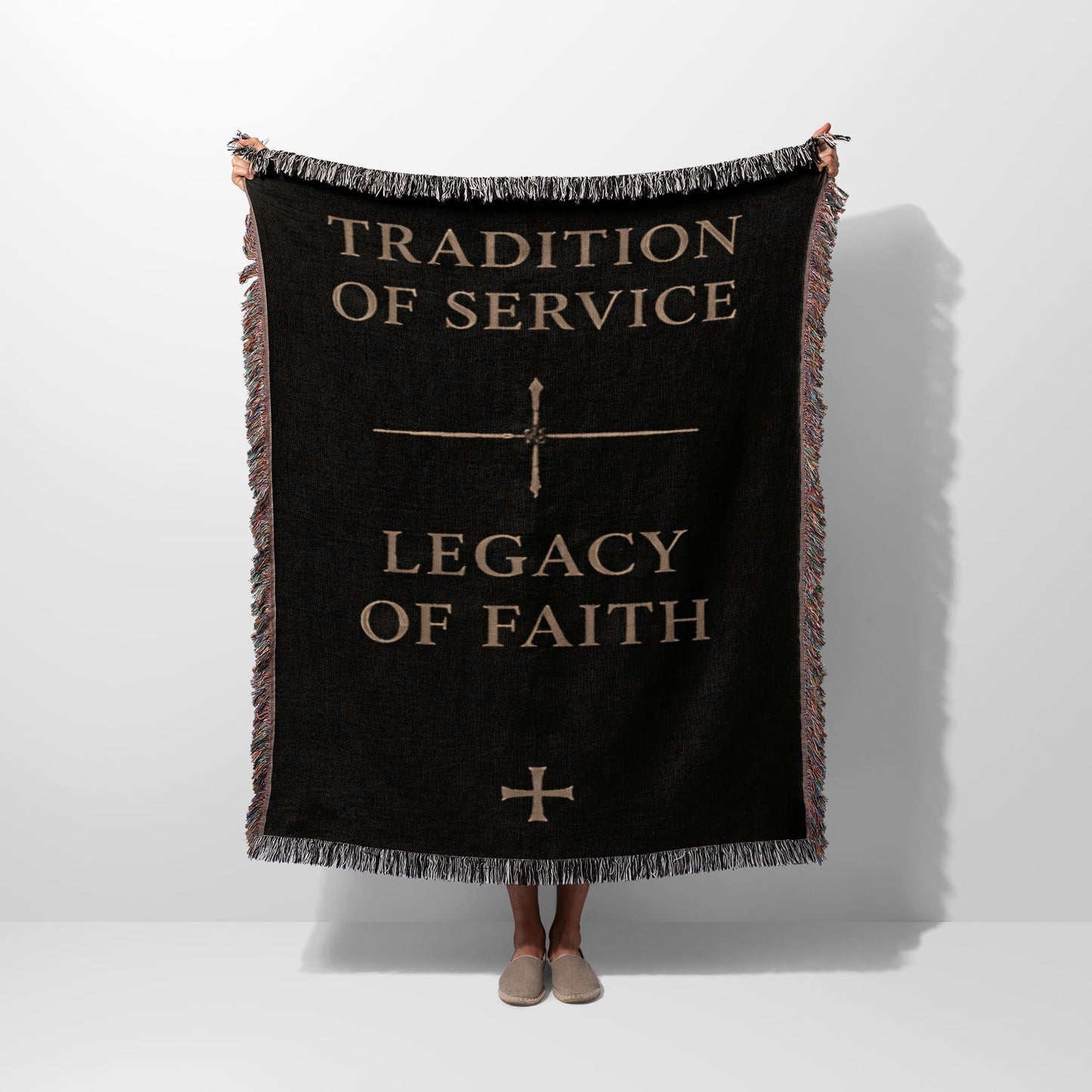 Black woven throw blanket with "Tradition of Service" and "Legacy of Faith" text.