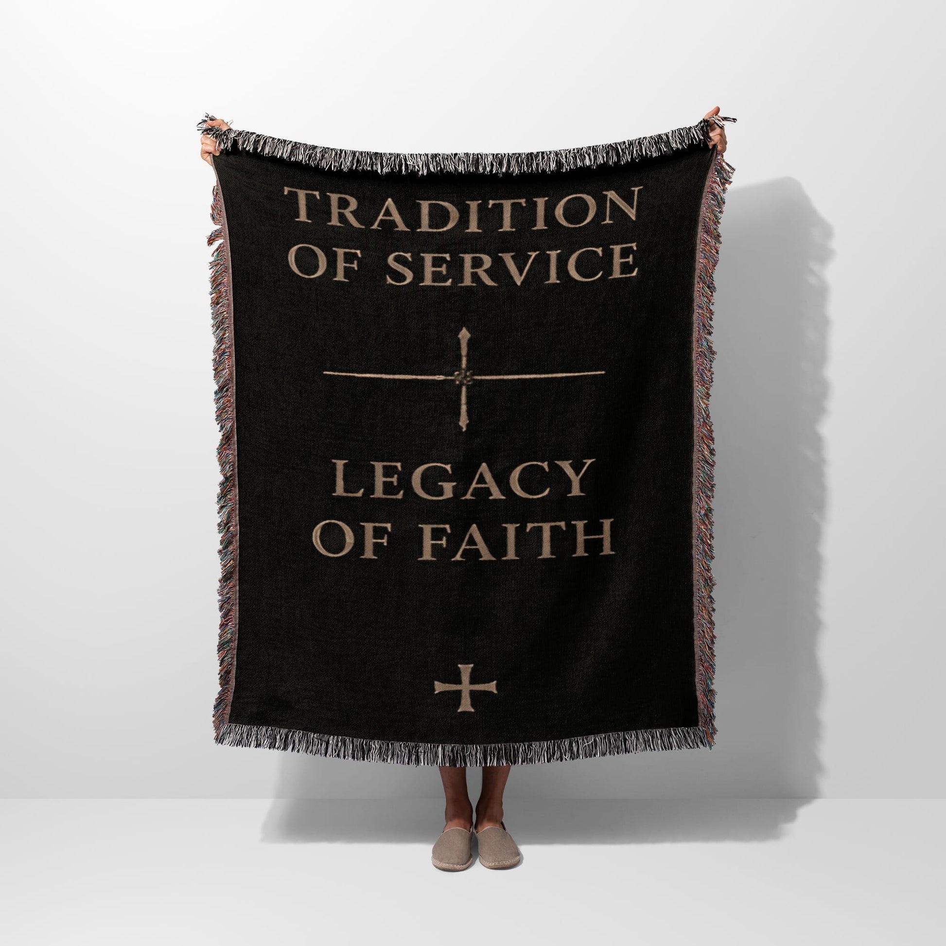 Black woven throw blanket with "Tradition of Service" and "Legacy of Faith" text.