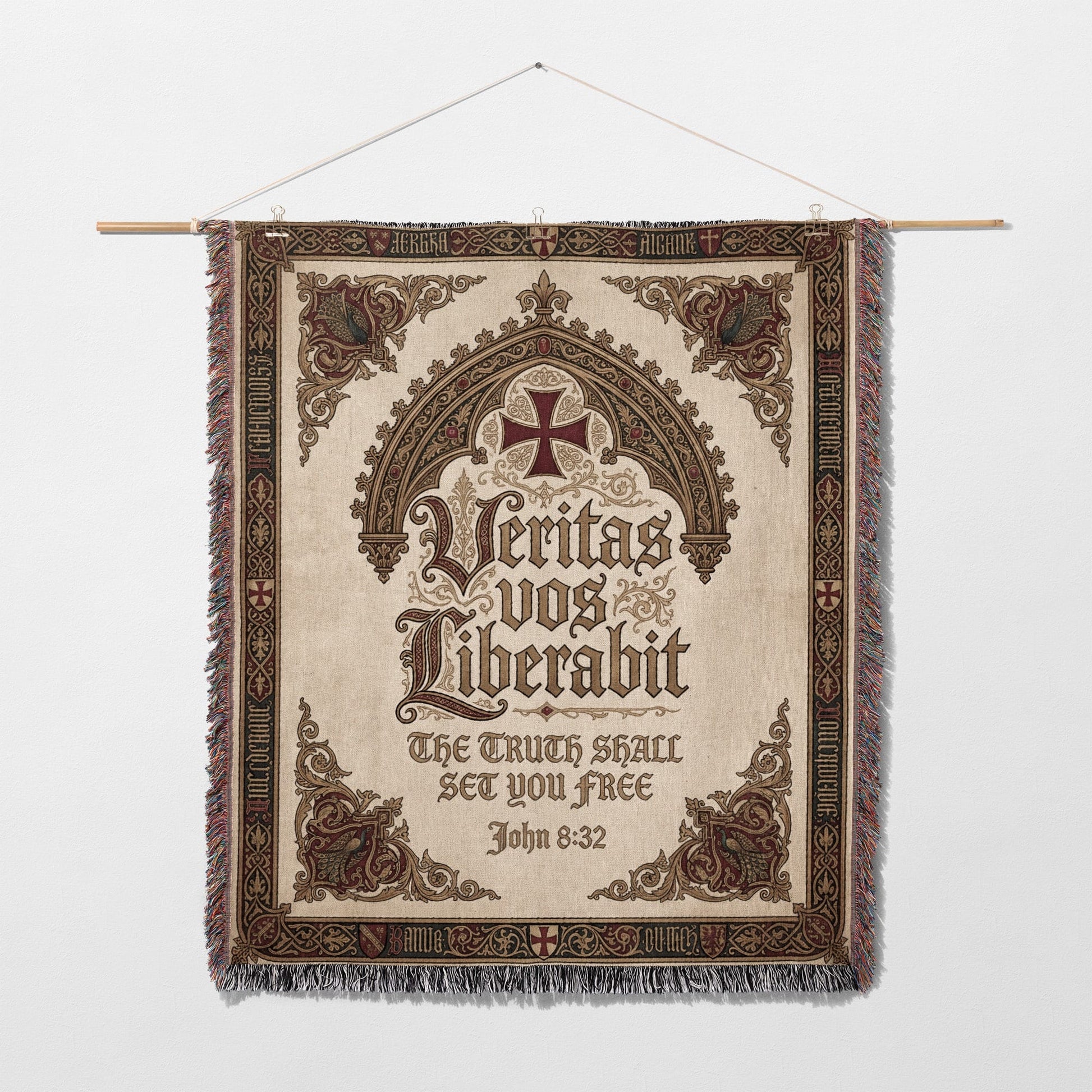 Tapestry with ornate border, featuring a cross and Latin text "Veritas vos liberabit" and "The truth shall set you free".