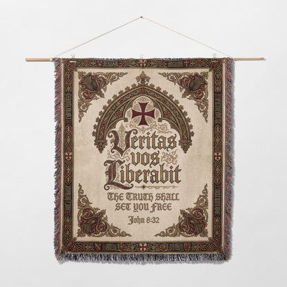 Tapestry with ornate border, featuring a cross and Latin text "Veritas vos liberabit" and "The truth shall set you free".