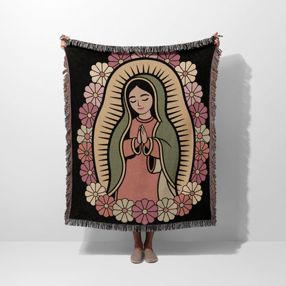 Virgin Mary surrounded by floral border, held by person.