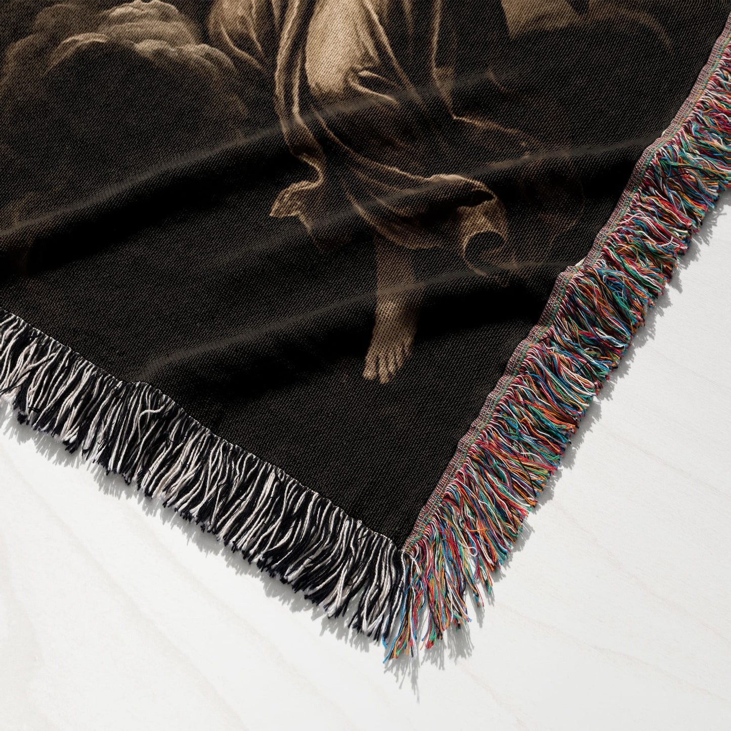 Woven tapestry throw with fringed edges, featuring a classical religious depiction.