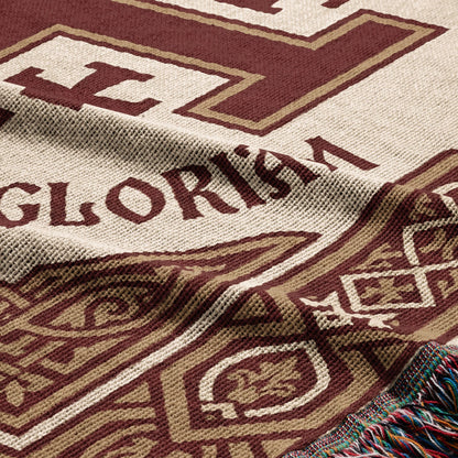 Close-up of a woven blanket with "GLORISMA" and decorative patterns.