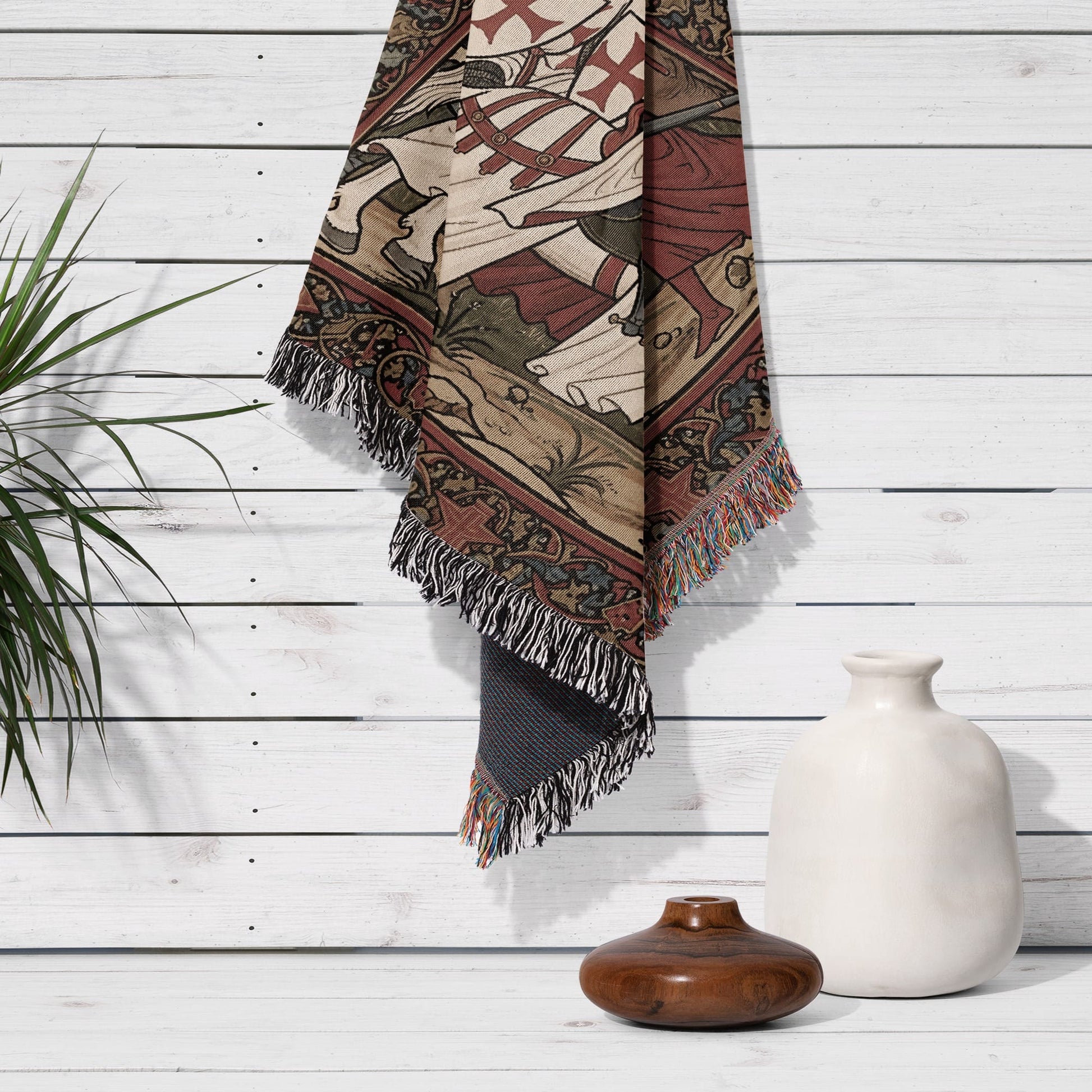 Woven tapestry with knight and horse design, fringed edges, displayed on white wood wall.