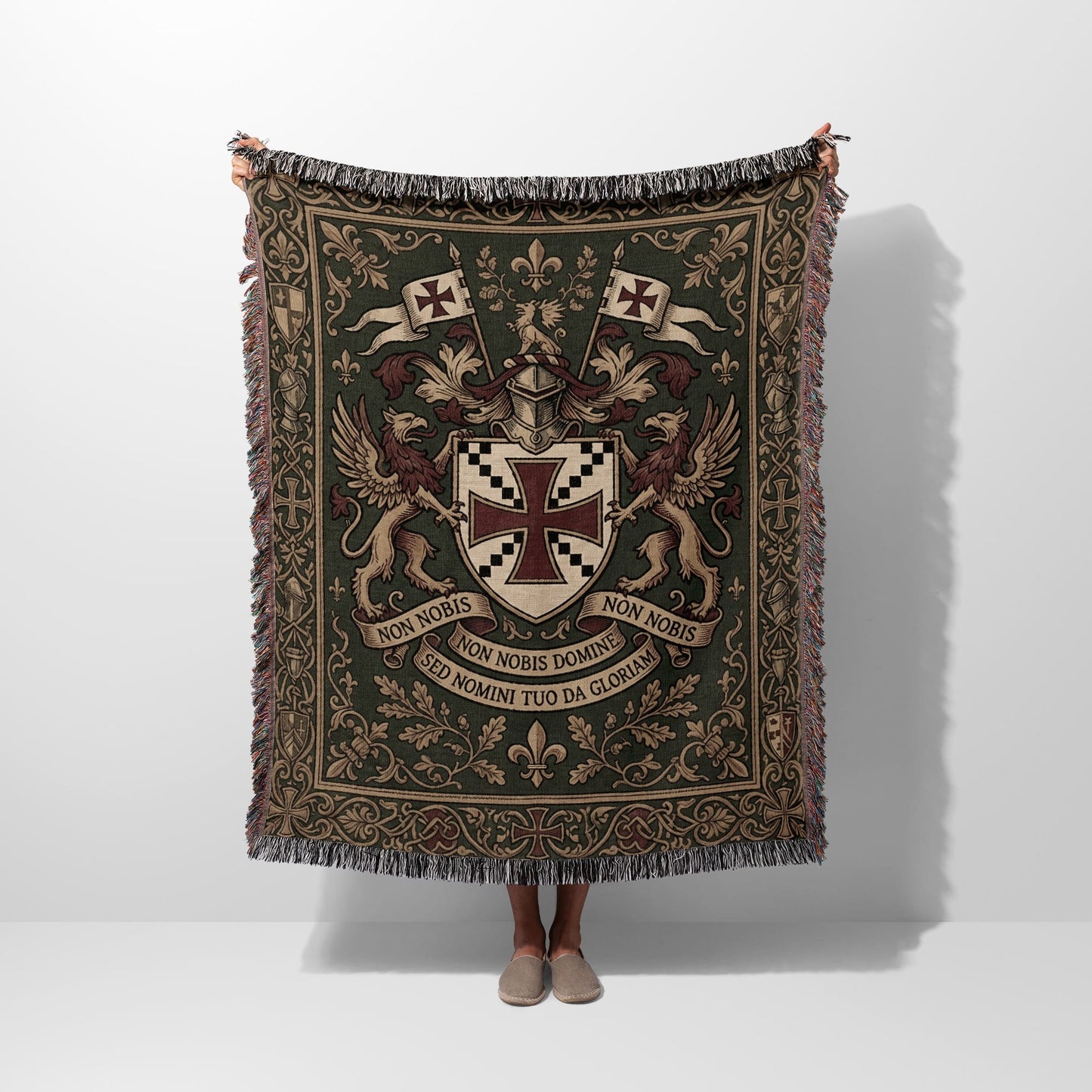 Green woven tapestry blanket with coat of arms, griffins, and Latin text.