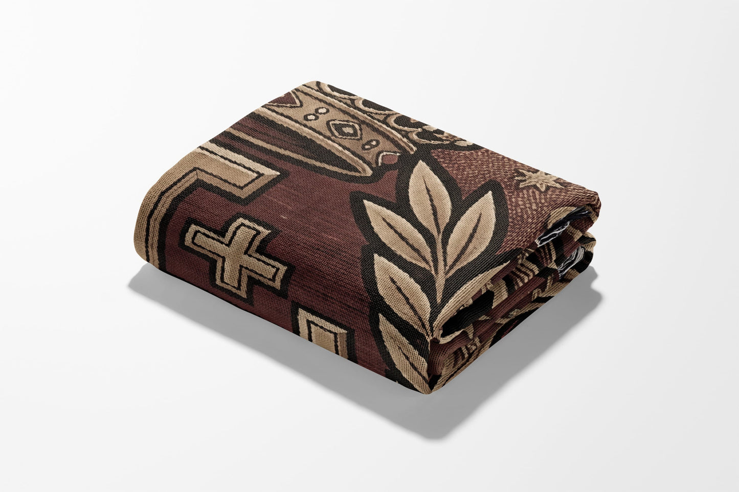 Folded blanket with geometric and floral patterns in brown and beige.