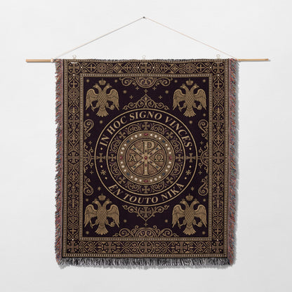 Dark tapestry with gold Byzantine eagles and Chi-Rho symbol, bearing Latin and Greek text.
