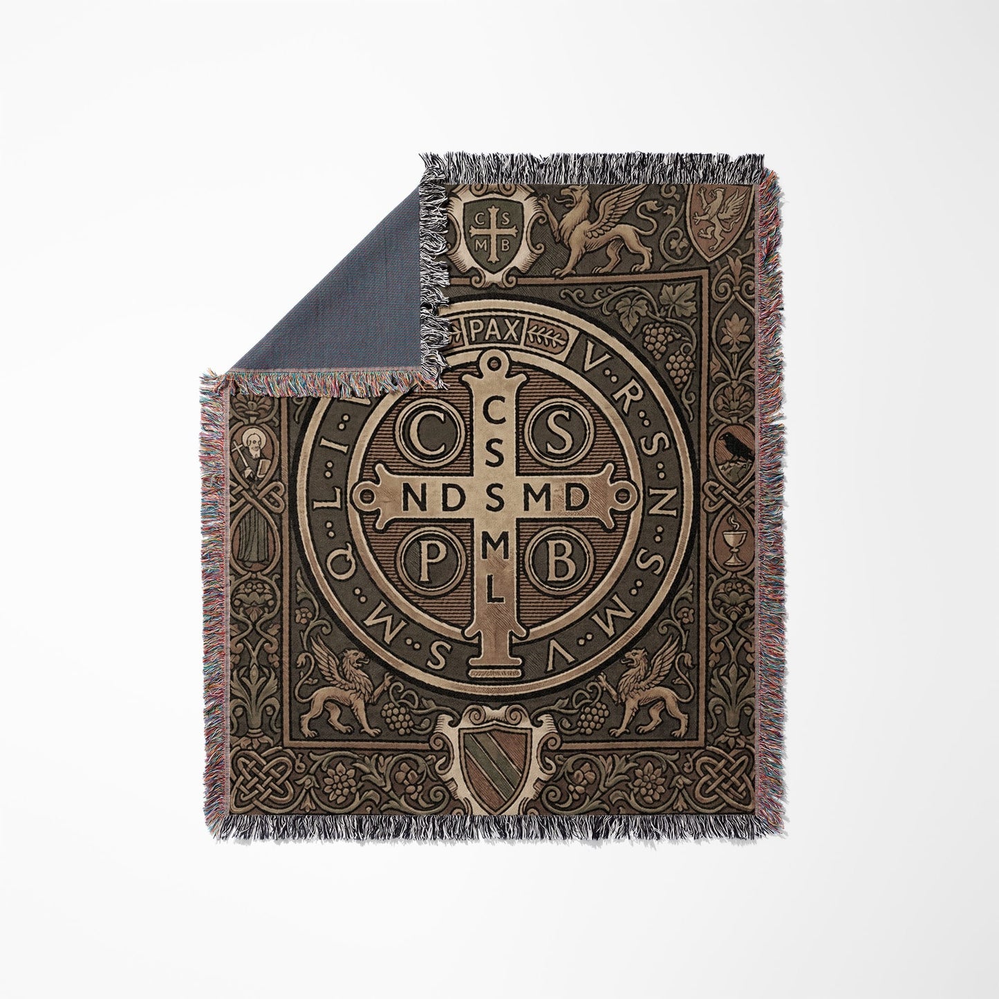 Woven throw blanket with Saint Benedict medal and ornate borders on white background.