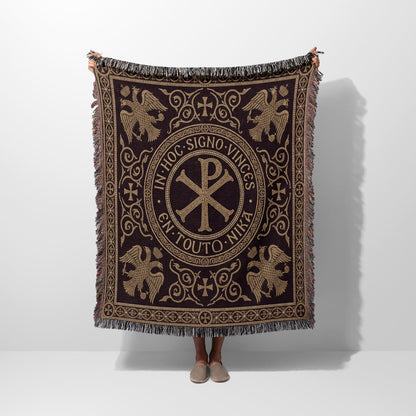 Embroidered blanket with Chi Rho and Latin inscription "In hoc signo vinces" framed by eagles.