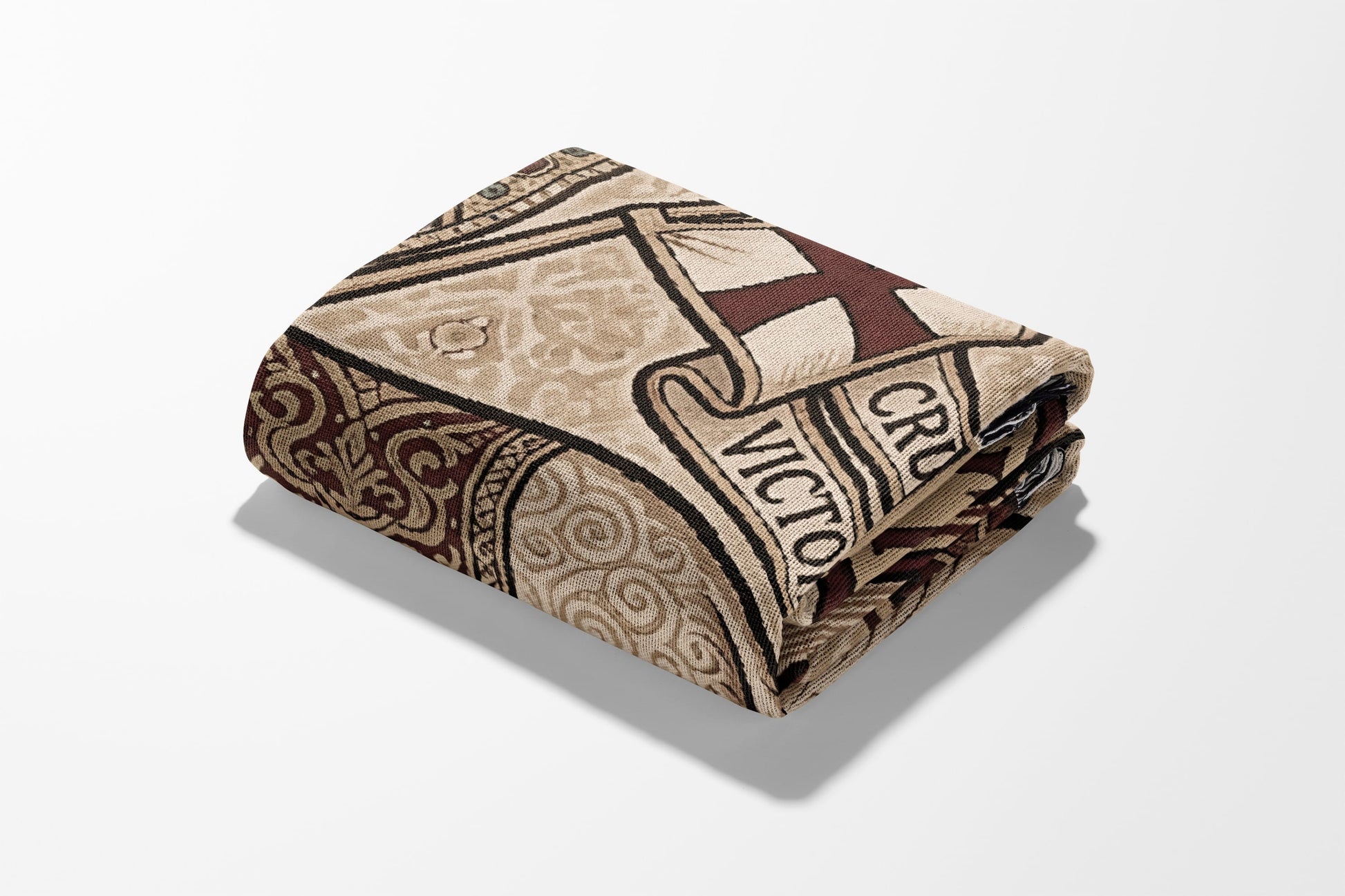 Folded tapestry with a cross and "VICTORIA" text on beige background.